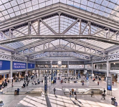 An elevated interior view of Moynihan Train Hall / Farley Building in Manhattan, New York City. Captured by architectural photographer Andrew Prokos for Vornado Realty Trust. The renovation architect is Skidmore, Owings & Merrill (SOM). Fine art prints are available framed in wood, metal and acrylic styles.