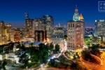 A cityscape photograph of Manhattan's Civic Center, City Hall, Municipal Building, and U.S. Customs House at dusk, New York City