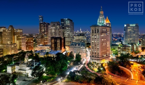A cityscape photograph of Manhattan's Civic Center, City Hall, Municipal Building, and U.S. Customs House at dusk, New York City