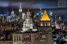 A fine art photograph of the Municipal Building, 40 Centre Street, and the skyscrapers of Midtown Manhattan and the Empire State Building at night in the distance, New York City