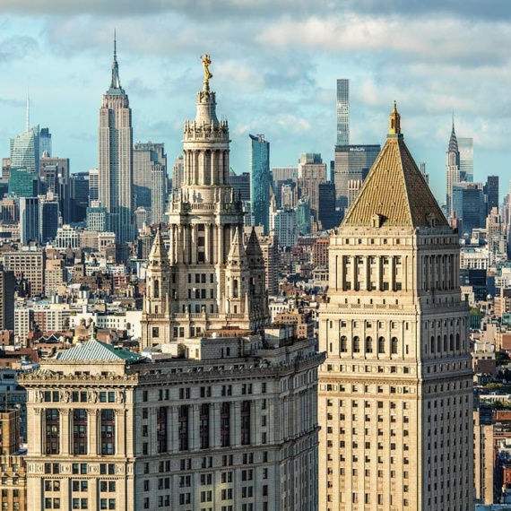 A view of the Municipal Building and 40 Centre Street in the foreground, with the skyscrapers of Midtown Manhattan and the Empire State Building in the distance, New York City