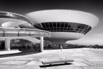 A black and white view of the Niteroi Contemporary Art Museum, Rio de Janeiro, Brazil. Uma vista do Museu de Arte Contemporânea em Niterói em preto e branco. Framed fine art prints of this photo are available up to 45 inches in width.