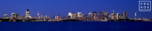 A panorama of New York City and NY Harbor at night as seen from New Jersey