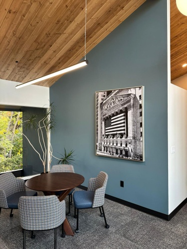 An acrylic face-mounted fine art print of New York Stock Exchange with American Flags in black and white by photographer Andrew Prokos. The photo is framed with a brushed silver floater frame.