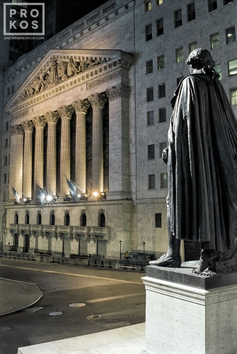 A view of the New York Stock Exchange (NYSE) and statue of George Washington at night from Federal Hall