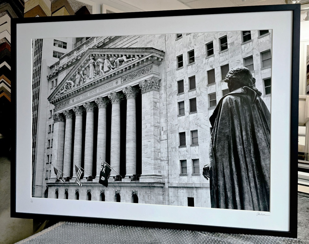 A forty inch black and white matted and framed fine art print of the New York Stock Exchange by photographer Andrew Prokos