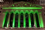 A fine art architectural photo of the illuminated facade of the New York Stock Exchange (NYSE) at night