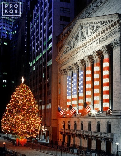 A fine art photo of the New York Stock Exchange (NYSE) with lighted Christmas tree as seen from Wall Street at night