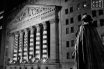 A black and white high-definition fine art photo of the New York Stock Exchange and statue of George Washington at night
