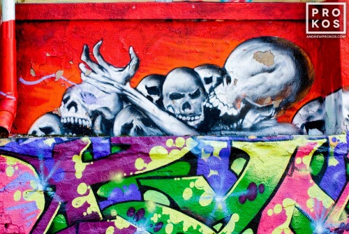 A colorful New York City street mural with skeletons. Framed fine art prints of this photo are available in various sizes.