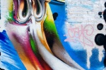A New York City Street mural of a cartoonish distorted face. Framed fine art prints of this photo are available in various sizes.