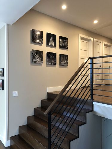 A collection of small prints of various New York City landmarks in black and white by photographer Andrew Prokos shown in a private residence in Long Island, NY