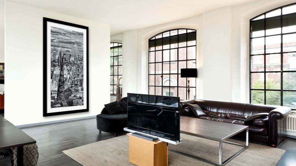 A NYC loft interior with a framed large-format black and white cityscape print by photographer Andrew Prokos on display.