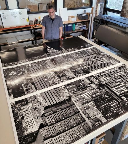 Photographer Andrew Prokos with a 90 inch limited edition cityscape of New York City at night, printed in three panels