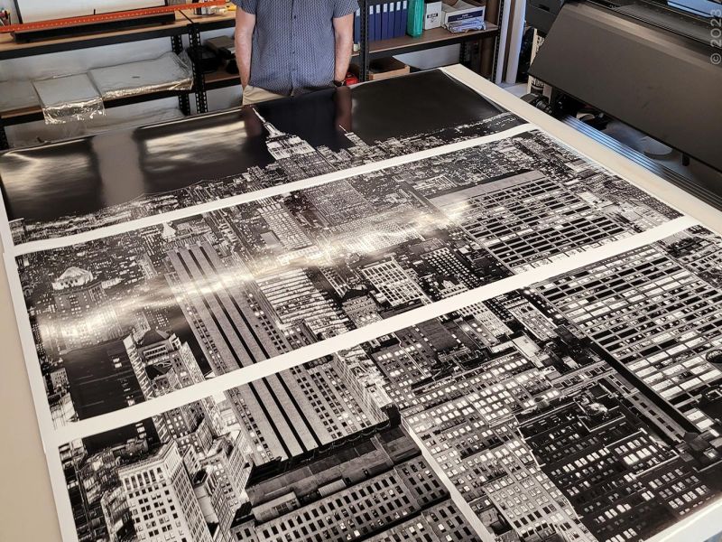 Photographer Andrew Prokos with a 90 inch limited edition cityscape of New York City at night, printed in three panels
