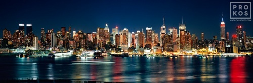A panoramic skyline photo of New York City as seen from Weehawken, New Jersey at night. Large-format fine art prints of this photo are available framed in various wood, metal, and acrylic styles.