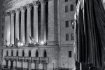 A fine art photo of the New York Stock Exchange (NYSE) and statue of George Washington at Federal Hall on Wall Street at night. Fine art prints of this photo are available framed in various styles. 
