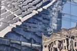 A large-scale abstract photograph capturing the warped reflections of New York City's Oculus on a glass facade in Lower Manhattan. Limited edition gallery prints of this photo are available up to 80 inches in height.