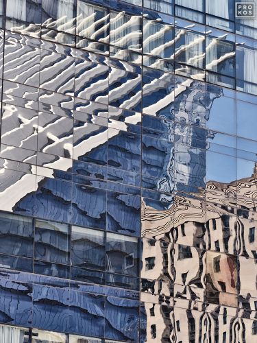 A large-scale abstract photograph capturing the warped reflections of New York City's Oculus on a glass facade in Lower Manhattan. Limited edition gallery prints of this photo are available up to 80 inches in height.