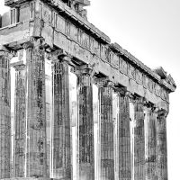 A black and white photograph of the Doric columns from the Eastern facade of the Parthenon in Athens, Greece