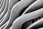 Black and white photography of a curved architectural facade made of cedarwood beams. Large-scale fine art prints of this photo are available up to 80 inches and framed in contemporary wood, metal and acrylic styles. 