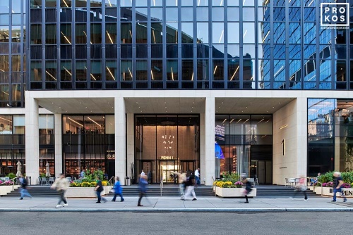 A street view of the exterior of Penn 1 tower with pedestrians, New York City, as seen during the day. Photographed by architectural photographer Andrew Prokos for Vornado Realty Trust. Andrew is available for commercial, advertising and architectural photo shoots worldwide.
