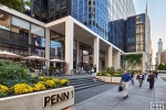 A street view of the exterior of Penn 1 tower with pedestrians, New York City, as seen during the day. Photographed by architectural photographer Andrew Prokos for Vornado Realty Trust. Fine art prints of this photo are available in various sizes.