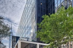 A street view of the exterior of Penn 1 tower with pedestrians, New York City, as seen during the day. Photographed by architectural photographer Andrew Prokos for Vornado Realty Trust. Fine art prints of this photo are available in various sizes.