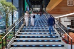 An interior view of the illuminated Digital Stairs at Penn 1 tower, New York City. The interior architect is A+I (architecture Plus Information). Photographed by architectural photographer Andrew Prokos for Vornado Realty Trust. Fine art prints of this photo are available in various sizes.