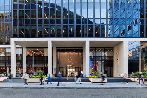 A street view of the exterior of Penn 1 tower with pedestrians, New York City, as seen during the day. Photographed by architectural photographer Andrew Prokos for Vornado Realty Trust. Fine art prints of this photo are available in various sizes.