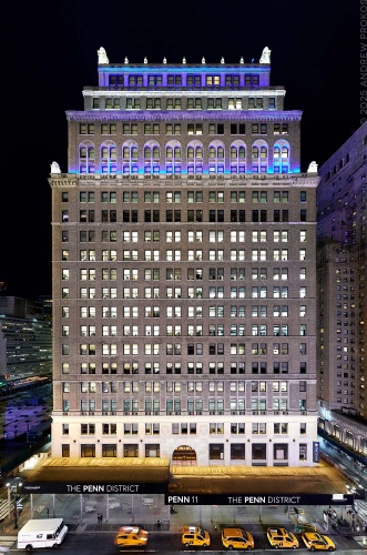 A wide angle (hero) view of Penn 11 tower as seen at night, New York City. Photographed by architectural photographer Andrew Prokos for Vornado Realty Trust.