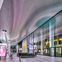 A view of the Bustle at Penn 2 tower as seen at night, New York City. Photographed by architectural photographer Andrew Prokos for Vornado / The Penn District. Fine art prints of this photo are available framed in various styles