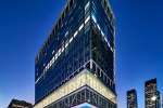 A view of Penn 2 tower, Madison Square Garden, and 7th Avenue in New York City at dusk. Photographed by architectural photographer Andrew Prokos for The Penn District / Vornado Realty Trust. Fine art prints of this photo are available in various sizes.
