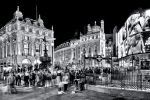 A black and white panoramic view of London's Picadilly Circus at night, United Kingdom. Limited edition fine art prints of this high-definition photo are available up to 96 inches in width and framed in various wood, metal, and acrylic styles.