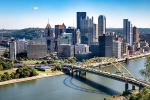 An ultra-high resolution panoramic skyline of Pittsburgh, Pennsylvania during the day.