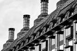 A black and white architectural photograph of the neo-gothic facade of Portcullis House, London, United Kingdom. Limited edition fine art prints of this photo are available up to 80 inches in height and framed in various wood, metal, and acrylic styles. 