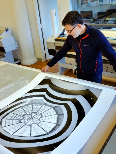 Photographer Andrew Prokos with a 48x36 inch monochrome limited edition print of Guggenheim Museum Interior V for Unit London Gallery.