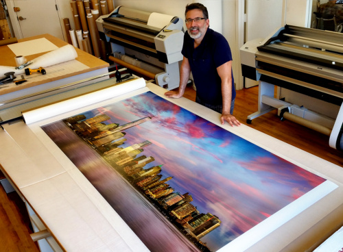 Photographer Andrew Prokos with an 80 inch limited edition print of "Panoramic View of Lower Manhattan and the World Trade Center at Dusk"