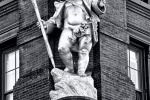 A fine art architectural photo of the statue of Puck on the facade of the Puck Building, NYC in black and white