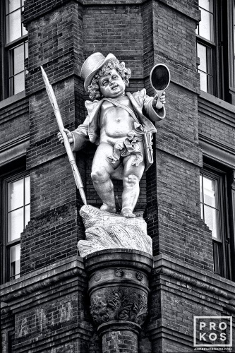 A fine art architectural photo of the statue of Puck on the facade of the Puck Building, NYC in black and white