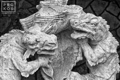 A black and white photo of the dragon statues in the Quinta da Regaleira gardens in black and white, Sintra, Portugal