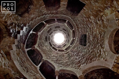 The Poco Iniciatico, a hidden well with arched spiral stairway in the Quinta da Regaleira gardens of Sintra, Portugal