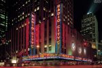 A long-exposure cityscape photo of Radio City Music Hall at night, New York City