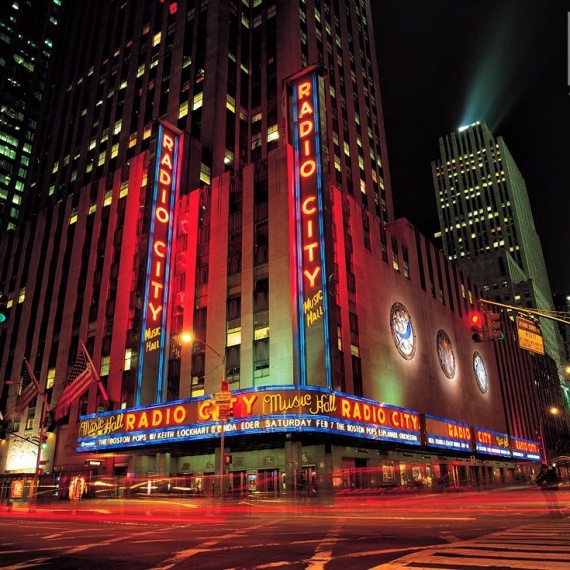 A long-exposure cityscape photo of Radio City Music Hall at night, New York City