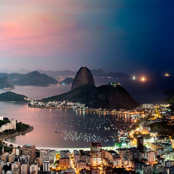 An ultra high-definition panoramic cityscape photo of Rio de Janeiro, Brazil transitioning from day to night, from Andrew's award-winning Night & Day series. Large-scale fine art prints of this photo are available up to 90 inches wide.
