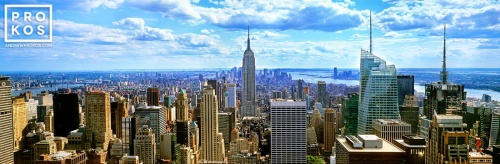 A large-format panoramic view of New York City and the Empire State Building as seen from the top of Rockefeller Center