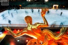 The famous art deco gilded statue of Prometheus overlooking ice skaters at night at New York City's Rockefeller Center during the Christmas holiday season. Fine art prints of this photo are available up to 60 inches in width and framed in wood, metal, and acrylic styles. 