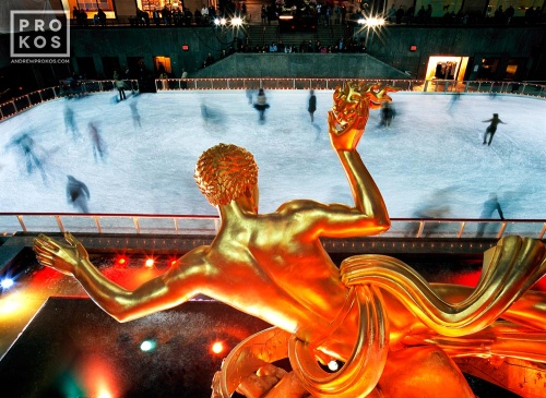 The famous art deco gilded statue of Prometheus overlooking ice skaters at night at New York City's Rockefeller Center during the Christmas holiday season. Fine art prints of this photo are available up to 60 inches in width and framed in wood, metal, and acrylic styles. 