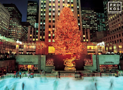 A long-exposure photo of the ice skaters under the lighted Christmas tree at Rockefeller Center, New York City