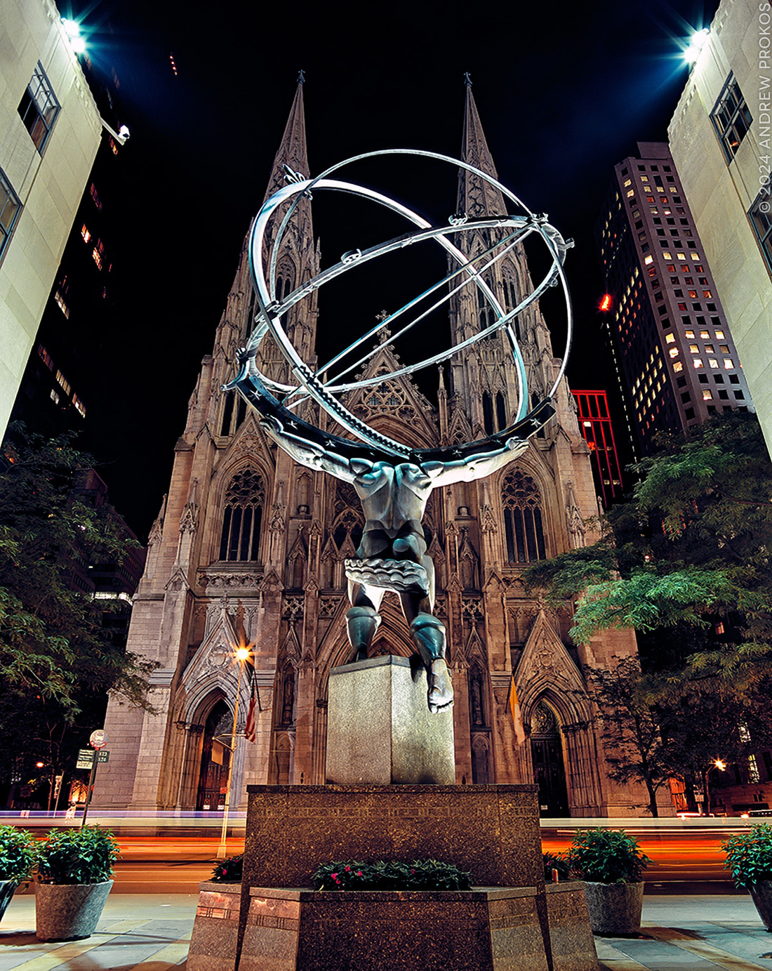 A view of Rockefeller Center's Atlas statue and St. Patrick's Cathedral at night, New York City.